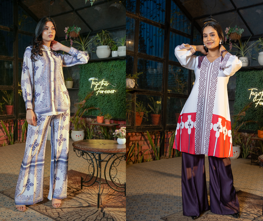 Two women wearing elegant Indo-western co-ord sets from Vyora by Vaishali, posing in a garden-themed indoor setting with a "Together Forever" neon sign in the background.